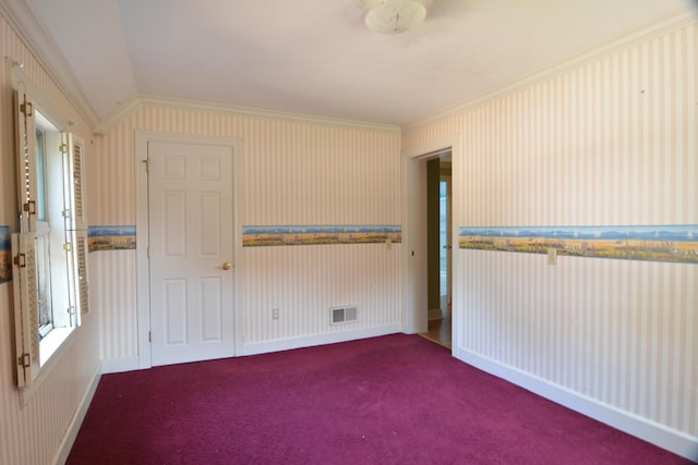 empty room with carpet floors, vaulted ceiling, and ornamental molding