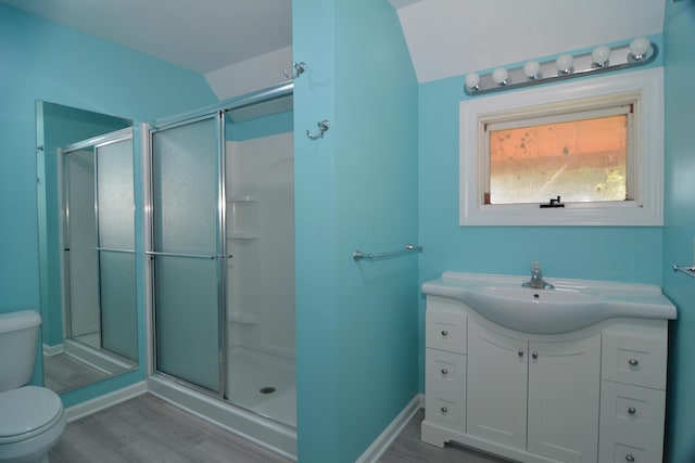 bathroom featuring hardwood / wood-style floors, toilet, and an enclosed shower