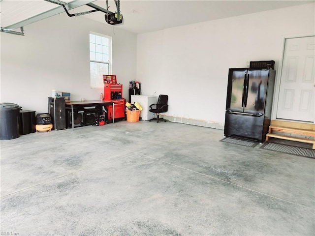 garage featuring a garage door opener and refrigerator