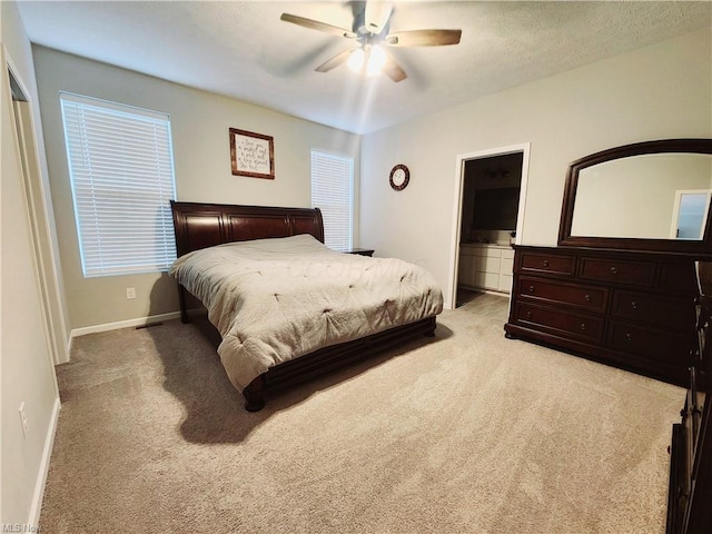 bedroom with ceiling fan and light colored carpet