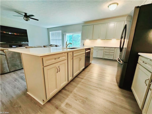 kitchen with light wood-type flooring, stainless steel refrigerator, dishwasher, and a center island