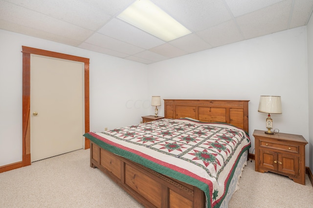 carpeted bedroom with a drop ceiling