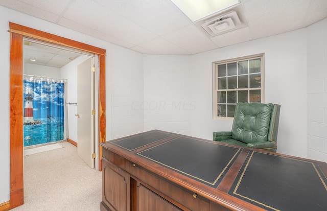 office space with a drop ceiling and light colored carpet