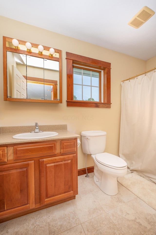 bathroom with tile patterned floors, vanity, and toilet