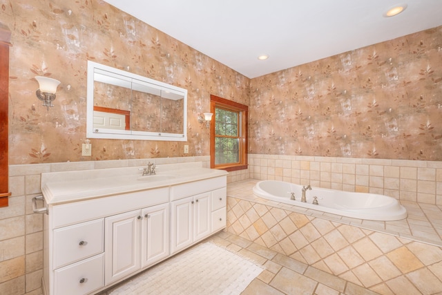 bathroom featuring vanity, a relaxing tiled tub, and tile patterned floors