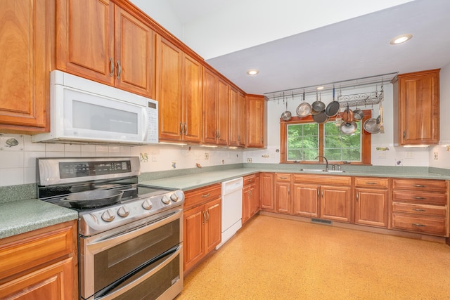 kitchen featuring white appliances and sink