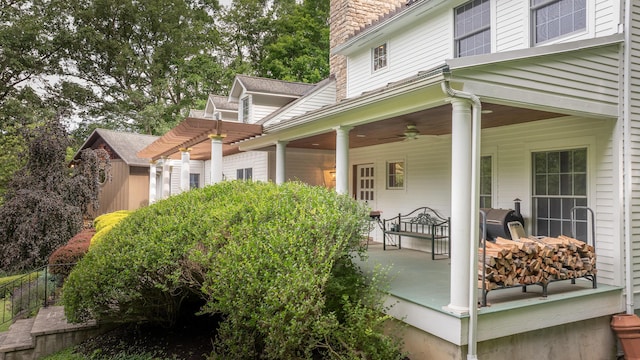 exterior space with a pergola, ceiling fan, and covered porch