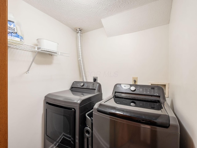2124 Ripple Rd, Hilliard, OH 43026 - laundry area featuring separate washer and dryer and a textured ceiling