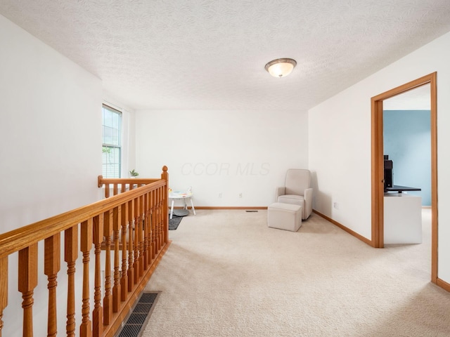 2124 Ripple Rd, Hilliard, OH 43026 - living area with carpet flooring, an upstairs landing, baseboards, and a textured ceiling