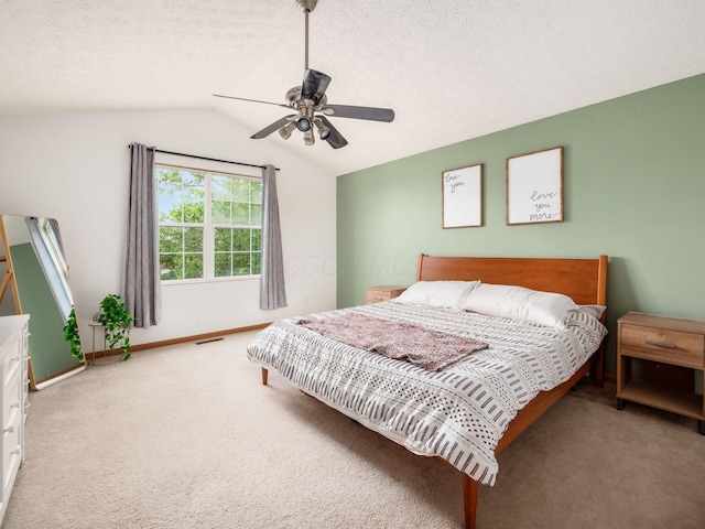 2124 Ripple Rd, Hilliard, OH 43026 - bedroom with carpet flooring, vaulted ceiling, baseboards, ceiling fan, and a textured ceiling