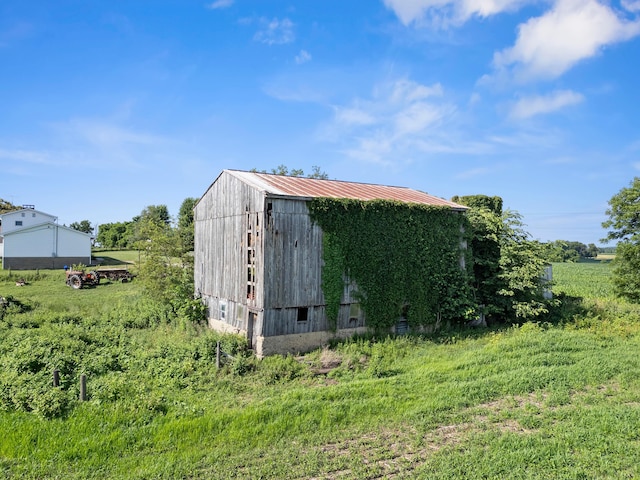 12943 Cooksey Rd, Utica, OH 43080 - view of side of home with an outdoor structure, a metal roof, and a pole building