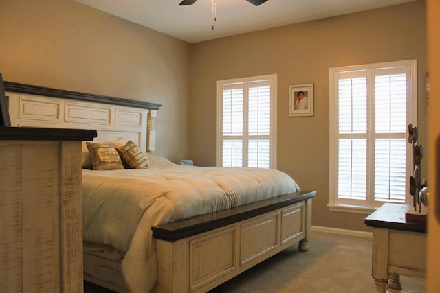 bedroom with carpet, ceiling fan, and multiple windows