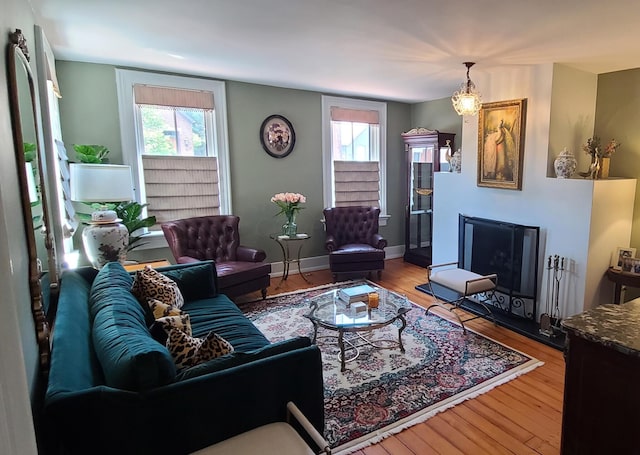 living room with wood-type flooring and an inviting chandelier