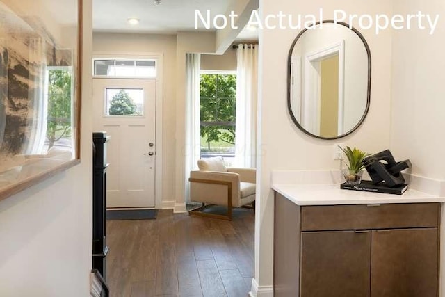 doorway to outside with dark wood-style floors