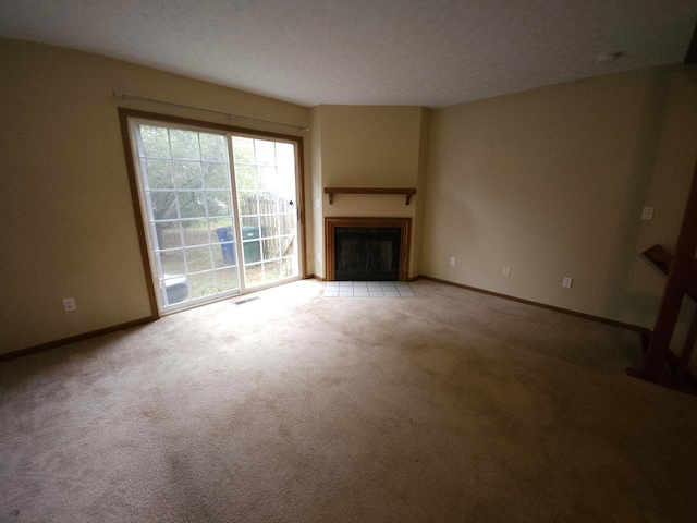 unfurnished living room featuring carpet flooring and a textured ceiling