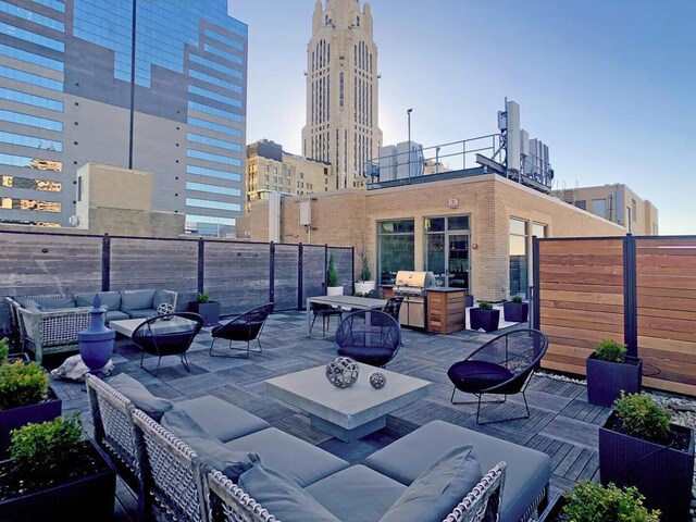 view of patio featuring area for grilling and an outdoor living space with a fire pit