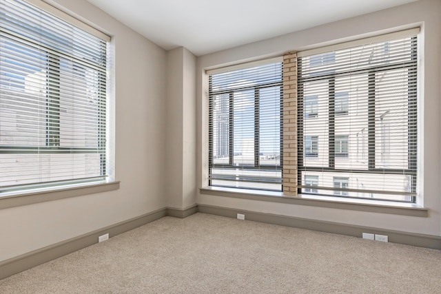 unfurnished room featuring carpet