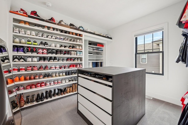 spacious closet featuring dark colored carpet