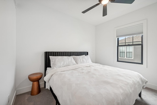 carpeted bedroom featuring ceiling fan and baseboards