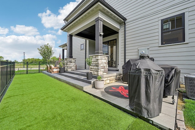 rear view of house with a patio area, a fenced backyard, a yard, and central AC unit