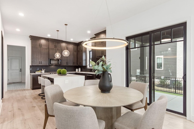 dining room featuring light wood finished floors and recessed lighting