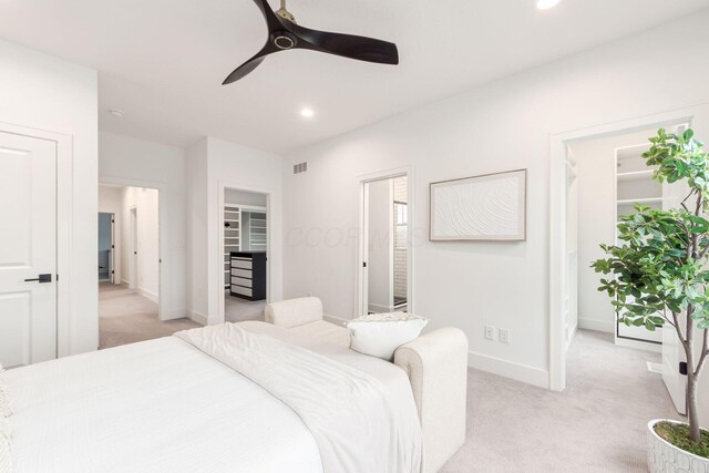 bedroom featuring recessed lighting, visible vents, light colored carpet, a spacious closet, and baseboards