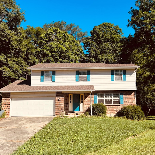 view of front of house featuring a garage and a front lawn