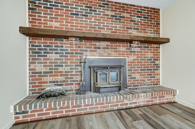 room details featuring hardwood / wood-style floors and a wood stove