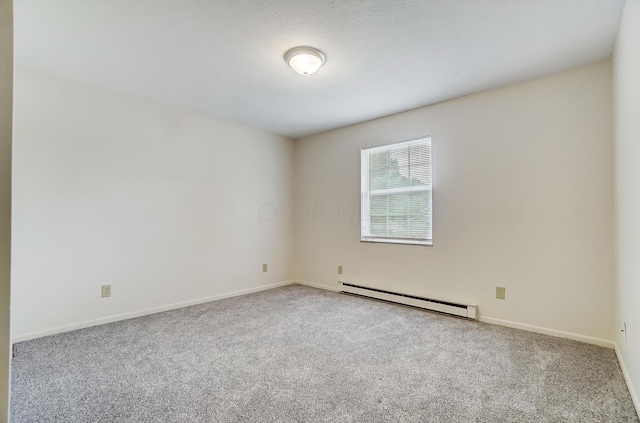 empty room featuring carpet, a textured ceiling, and a baseboard heating unit