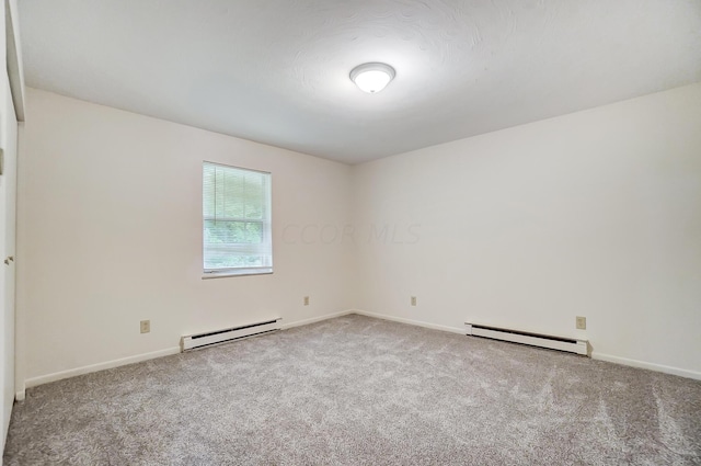 empty room featuring carpet and baseboard heating