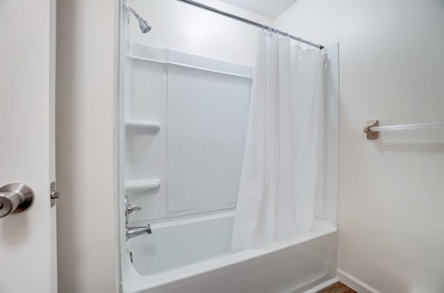 bathroom featuring shower / bathtub combination with curtain