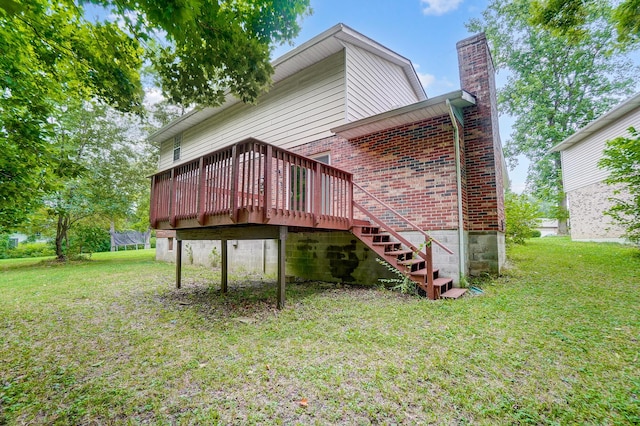 back of property with a yard and a wooden deck