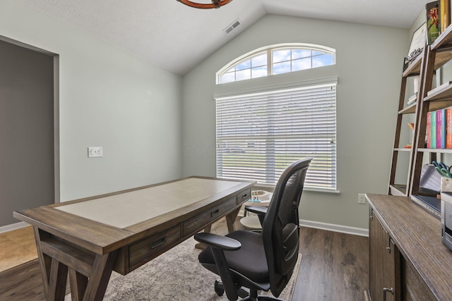 office area with vaulted ceiling, a textured ceiling, and dark hardwood / wood-style floors