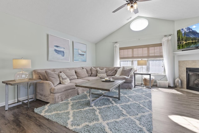 living room with ceiling fan, a fireplace, high vaulted ceiling, and dark hardwood / wood-style floors