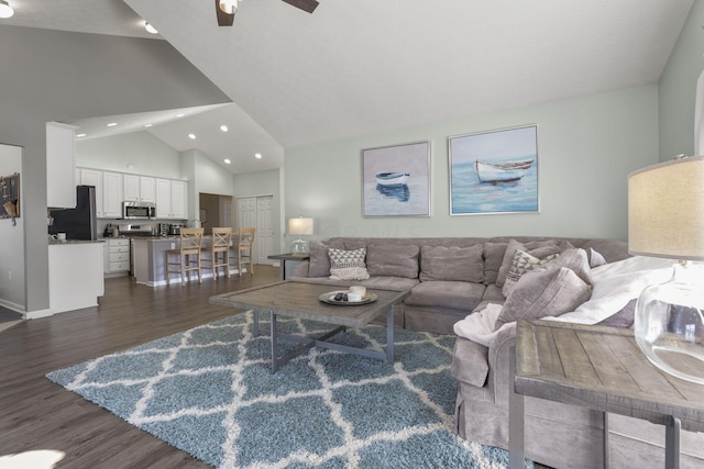 living room with high vaulted ceiling, ceiling fan, and dark wood-type flooring