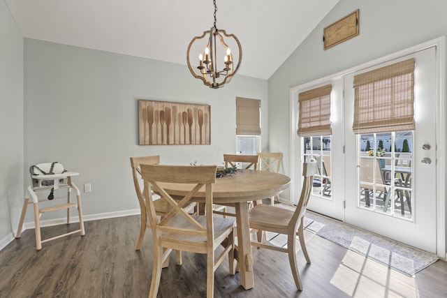 dining area with a chandelier, wood-type flooring, and vaulted ceiling