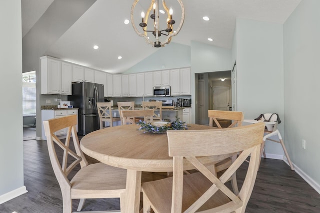 dining room with dark hardwood / wood-style flooring, high vaulted ceiling, and a notable chandelier