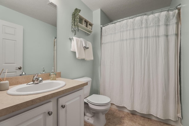 bathroom featuring curtained shower, tile patterned floors, a textured ceiling, toilet, and vanity