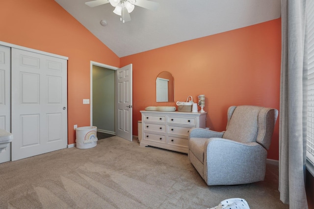 sitting room with light colored carpet, vaulted ceiling, and ceiling fan