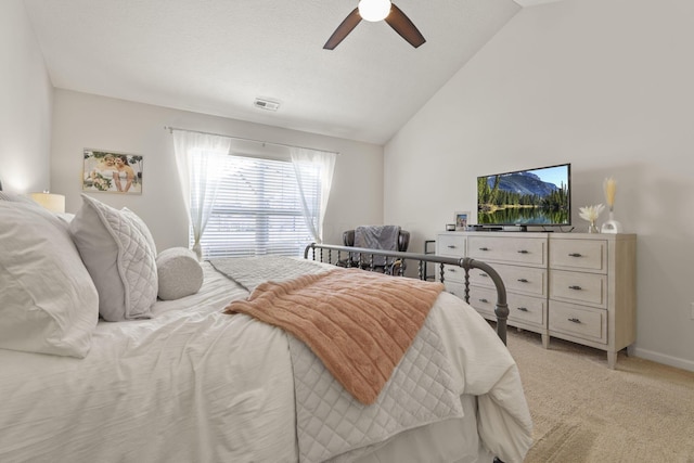 carpeted bedroom with ceiling fan and vaulted ceiling