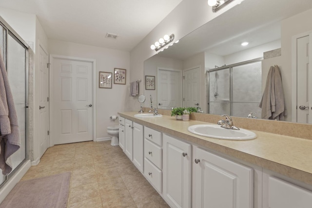 bathroom with toilet, vanity, tile patterned floors, and walk in shower