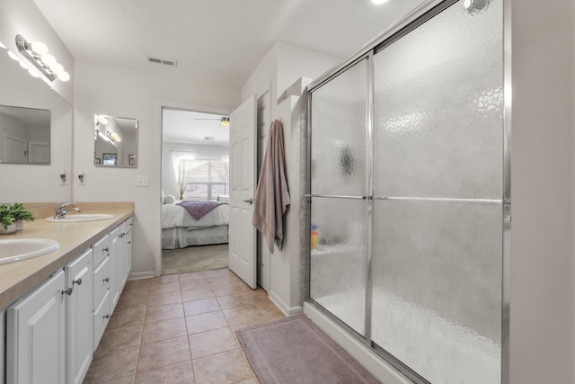 bathroom with tile patterned flooring, vanity, ceiling fan, and a shower with shower door