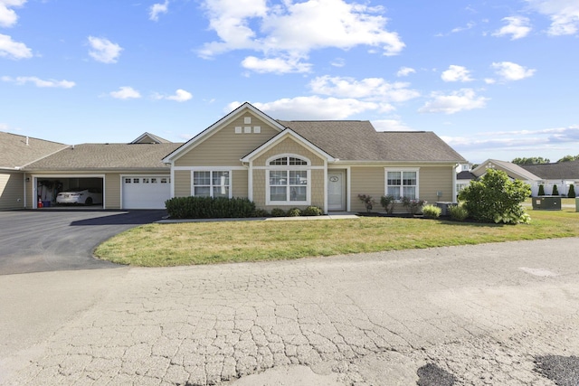 single story home featuring a front yard and a garage