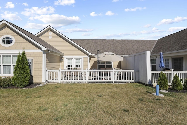 rear view of property featuring a yard