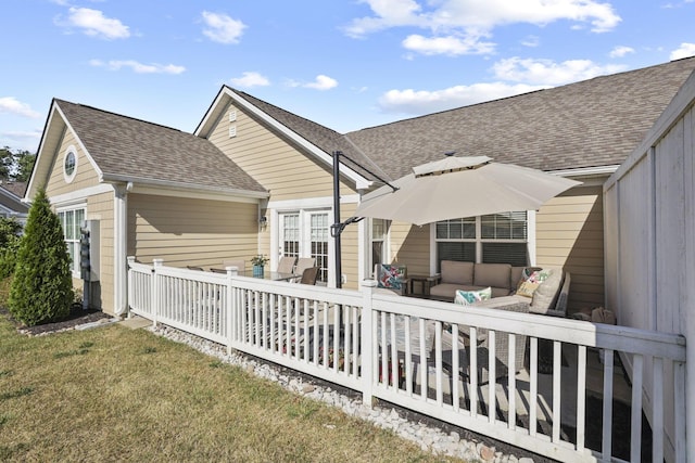 rear view of property featuring a lawn