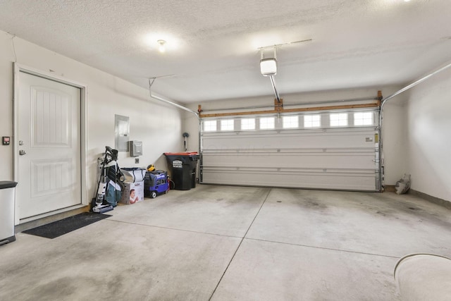 garage with electric panel and a garage door opener