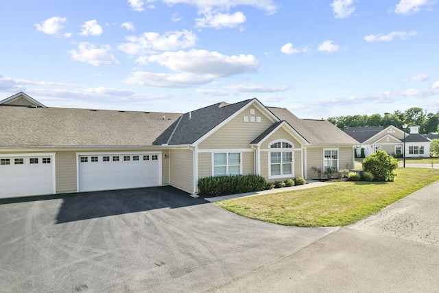 ranch-style home with a garage and a front yard