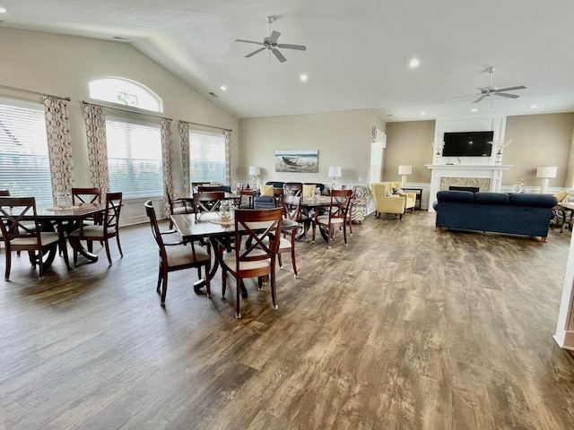 dining space featuring wood-type flooring, ceiling fan, and lofted ceiling