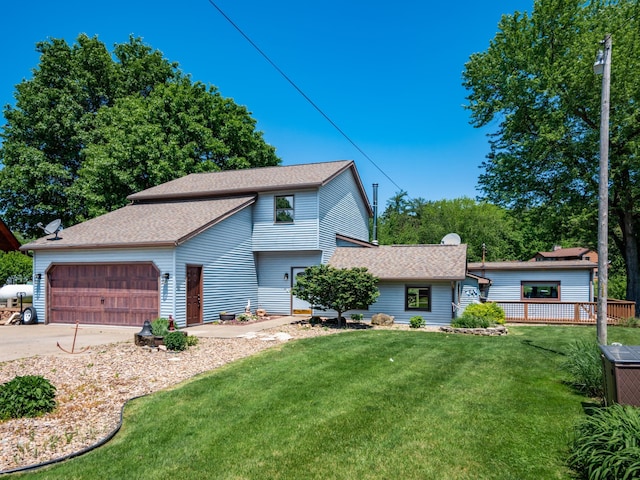 view of front of house featuring a garage and a front lawn