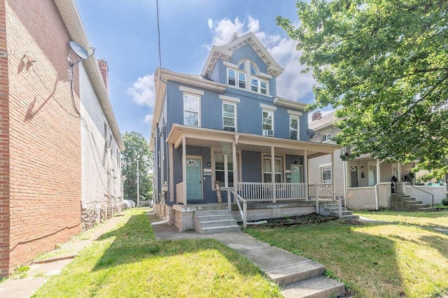 view of front of home featuring a front lawn and covered porch